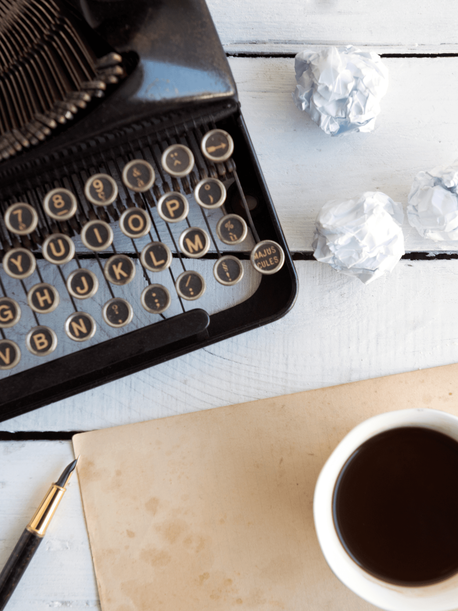 typewriter, coffee, crumbled balls of paper