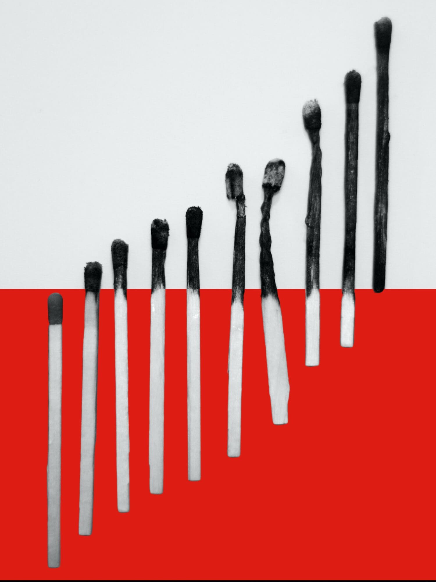 Burnt matches arranged in a line, fading from whole to charred, showing the progression of purser burnout.