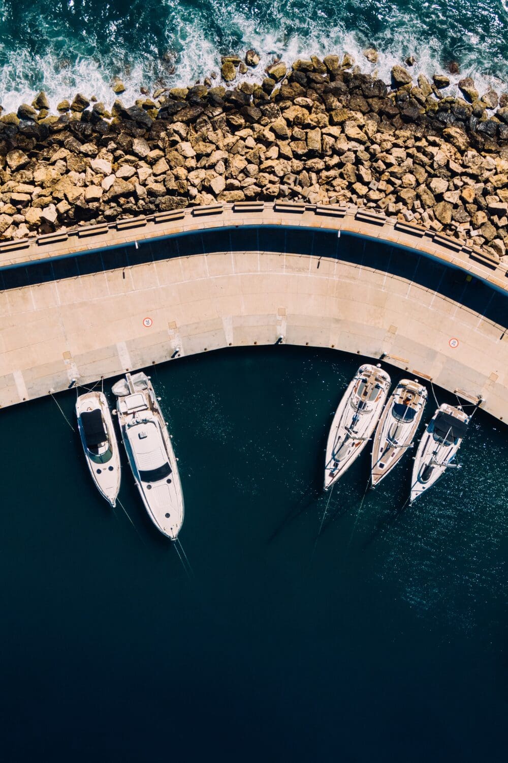 Luxury yachts moored in a quiet marina, symbolising awareness and the refined yacht purser skills behind smooth operations.